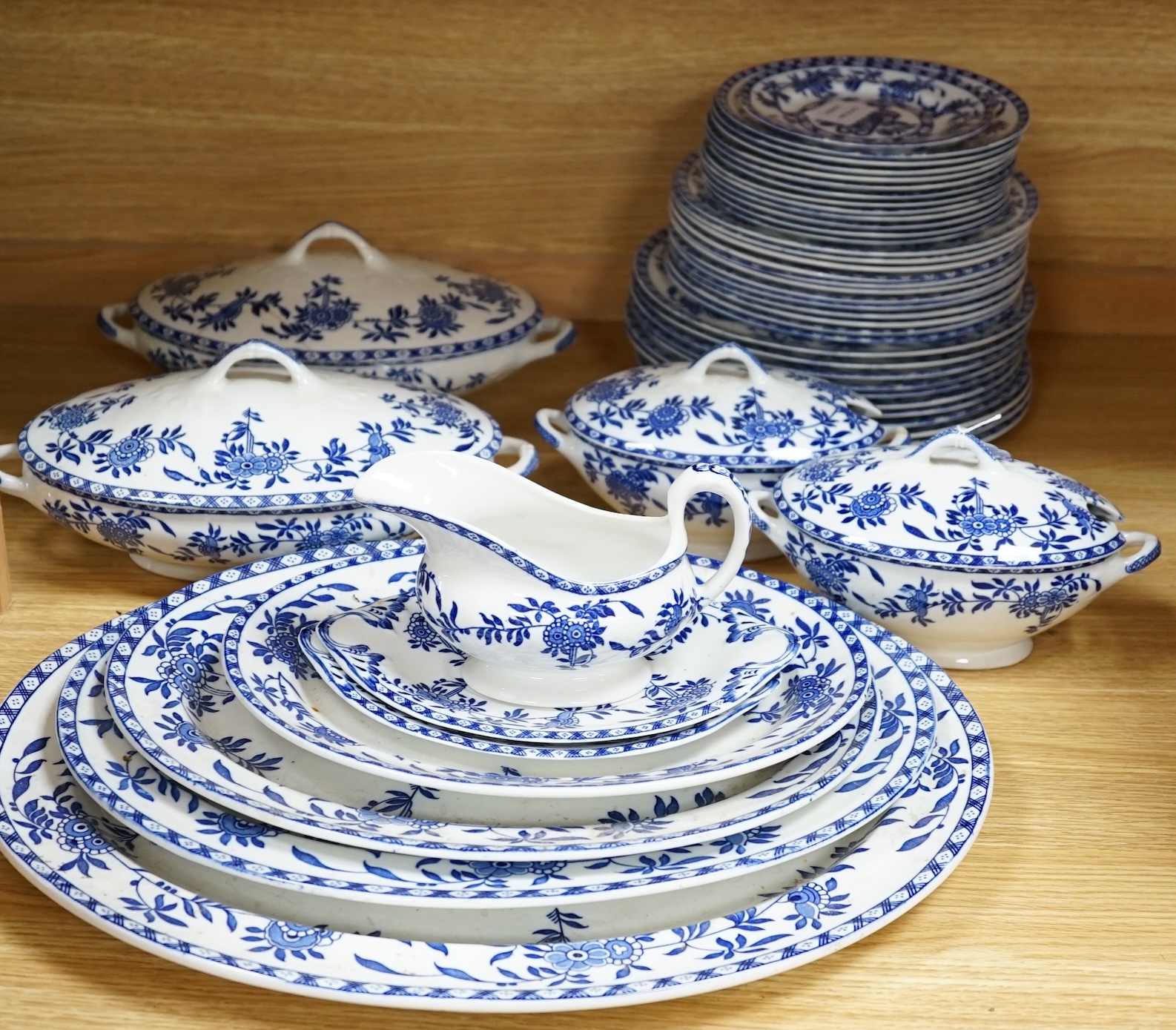 A mixed Wood and Sons ‘Delph’ patterned blue and white dinner service, including oval meat platters, various sized plates and two pairs of tureens and covers. Condition - fair to good